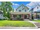 Charming two-story home with a lush green lawn and inviting front porch at 1826 N Alabama St, Indianapolis, IN 46202