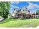 Lovely home featuring mature trees, a spacious lawn, and a welcoming front porch at 1826 N Alabama St, Indianapolis, IN 46202