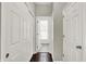 Hallway leading to bathroom; includes multiple closets and dark wood floors at 1826 N Alabama St, Indianapolis, IN 46202