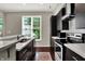 Modern kitchen features stainless steel appliances, gas range, and dark cabinets at 1826 N Alabama St, Indianapolis, IN 46202