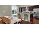 Eat-in kitchen features dark cabinets, stainless appliances, bar seating and modern décor at 1826 N Alabama St, Indianapolis, IN 46202