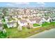 Aerial view of a neighborhood with well-manicured lawns, lush green trees, and a shared lake at 1839 Silverton Dr, Avon, IN 46123