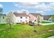 Well maintained backyard with a deck, trampoline, lush green lawn, trees, and white picket fence at 1839 Silverton Dr, Avon, IN 46123