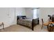 Comfortable bedroom features a wood-framed bed with patterned bedding, creating a cozy and inviting space at 1839 Silverton Dr, Avon, IN 46123