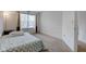 Bright bedroom with a large window, neutral carpet, and a cozy, patterned blue and white bedspread at 1839 Silverton Dr, Avon, IN 46123