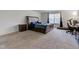 Spacious bedroom featuring a large bed, a nightstand, a window, and an open area for a treadmill at 1839 Silverton Dr, Avon, IN 46123