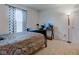 Bedroom with a wood-framed bed and patterned bedding, complemented by a desk and ample natural light at 1839 Silverton Dr, Avon, IN 46123