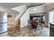Bright dining area featuring tile floors, a staircase, and adjacent living area at 1839 Silverton Dr, Avon, IN 46123