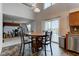 Bright dining area with modern light fixture, wood table, and access to deck at 1839 Silverton Dr, Avon, IN 46123