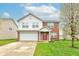 Charming two-story home featuring a brick and vinyl facade, attached garage, and a well-maintained lawn at 1839 Silverton Dr, Avon, IN 46123