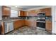 Well-equipped kitchen featuring wood cabinetry, stainless steel appliances, and a stylish backsplash for a modern touch at 1839 Silverton Dr, Avon, IN 46123