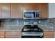 Beautiful kitchen showcasing stainless steel appliances, wood cabinets, and stylish backsplash, creating a modern cooking space at 1839 Silverton Dr, Avon, IN 46123