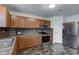Functional kitchen featuring wood cabinetry, stainless steel appliances, and durable flooring for easy maintenance at 1839 Silverton Dr, Avon, IN 46123