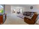 Spacious living room with a plush, oversized sofa, neutral carpeting, and views into the dining and kitchen areas at 1839 Silverton Dr, Avon, IN 46123