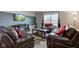 Comfortable living room with leather furniture, media center, and natural light at 1839 Silverton Dr, Avon, IN 46123