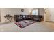 Comfortable living room featuring a reclining sofa, plush carpeting, and a patterned area rug for added style at 1839 Silverton Dr, Avon, IN 46123