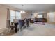 Open-concept living space featuring a modern chandelier, plush chairs, and neutral carpeting for a comfortable feel at 1839 Silverton Dr, Avon, IN 46123