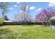 A spacious backyard with a wooden fence and trees, providing a serene outdoor space at 1933 Ruth Dr, Indianapolis, IN 46240
