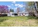 Expansive backyard featuring a wooden deck attached to the home and an enclosed screened-in porch at 1933 Ruth Dr, Indianapolis, IN 46240