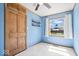 Bedroom with blue walls, a ceiling fan, one window, and a wooden closet at 1933 Ruth Dr, Indianapolis, IN 46240
