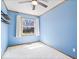 Bedroom with blue walls, a ceiling fan, one window, and floating shelves at 1933 Ruth Dr, Indianapolis, IN 46240