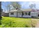 Charming single-story home with manicured lawn and inviting front entrance at 1933 Ruth Dr, Indianapolis, IN 46240