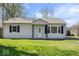 Well-maintained single-story home featuring a classic design and tidy landscaping at 1933 Ruth Dr, Indianapolis, IN 46240