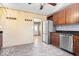 This kitchen features stainless steel appliances, stone backsplash, and wood cabinets at 1933 Ruth Dr, Indianapolis, IN 46240