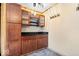 This kitchen features wood cabinetry, a black countertop, and stone backsplash at 1933 Ruth Dr, Indianapolis, IN 46240