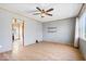 Spacious living room with laminate flooring, ceiling fan, and ample natural light at 1933 Ruth Dr, Indianapolis, IN 46240