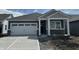 Charming single-story home featuring a two-car garage and a covered porch, complemented by a well-manicured lawn at 19565 Boulder Brook Ln, Westfield, IN 46074