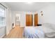 Bedroom featuring laminate floors, closet and view of bathroom creating a comfortable living space at 217 S 17Th Ave, Beech Grove, IN 46107