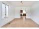 A bright dining room with wood floors, neutral walls, and a glimpse into the kitchen at 217 S 17Th Ave, Beech Grove, IN 46107
