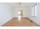 An airy dining room with wood floors and white walls leads to the living room at 217 S 17Th Ave, Beech Grove, IN 46107