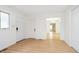 Bright hallway featuring laminate flooring with multiple doors, offering versatile access to different rooms at 217 S 17Th Ave, Beech Grove, IN 46107
