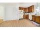 Traditional kitchen with wood cabinets, white appliances, laminate flooring and a bright, open feel at 217 S 17Th Ave, Beech Grove, IN 46107