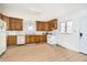 Well-lit kitchen with wood cabinets, white appliances, and a functional layout at 217 S 17Th Ave, Beech Grove, IN 46107