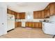 Bright kitchen featuring wood cabinets, white appliances, and ample counter space at 217 S 17Th Ave, Beech Grove, IN 46107