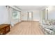 Bright living room featuring wood floors, neutral walls, and a floral sofa at 217 S 17Th Ave, Beech Grove, IN 46107
