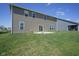 Backyard view showing the grassy yard and the exterior of the home with a patio at 2237 S Copperstone Dr, New Palestine, IN 46163