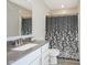 Cozy bathroom featuring a vanity with a sink, toilet, and a shower with a dark-patterned curtain at 2237 S Copperstone Dr, New Palestine, IN 46163