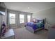 Bright bedroom featuring plush carpet, two windows, and a colorful bedspread, creating a cozy atmosphere at 2237 S Copperstone Dr, New Palestine, IN 46163