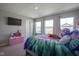 Cozy bedroom featuring plush carpet, television, and a colorful bedspread, creating a comfortable space at 2237 S Copperstone Dr, New Palestine, IN 46163