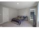 Comfortable bedroom with a stylish bed, side tables, and a partial view of the adjacent bathroom at 2237 S Copperstone Dr, New Palestine, IN 46163