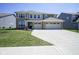 Stunning two-story brick home with a spacious three-car garage and well-manicured front yard at 2237 S Copperstone Dr, New Palestine, IN 46163