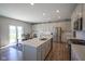 Bright kitchen featuring white cabinetry, stainless steel appliances, and a large center island at 2237 S Copperstone Dr, New Palestine, IN 46163
