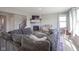 Comfortable living room with a fireplace, large sectional sofa, and ample natural light at 2237 S Copperstone Dr, New Palestine, IN 46163