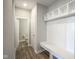 Mudroom with built-in bench, coat hooks, and shelving at 2237 S Copperstone Dr, New Palestine, IN 46163