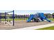 Community playground with swings and a large blue playset, perfect for Gathering fun and recreation at 2237 S Copperstone Dr, New Palestine, IN 46163