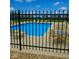 Community pool featuring a bright blue pool, lounge chairs and tables surrounded by a secure black fence at 2237 S Copperstone Dr, New Palestine, IN 46163